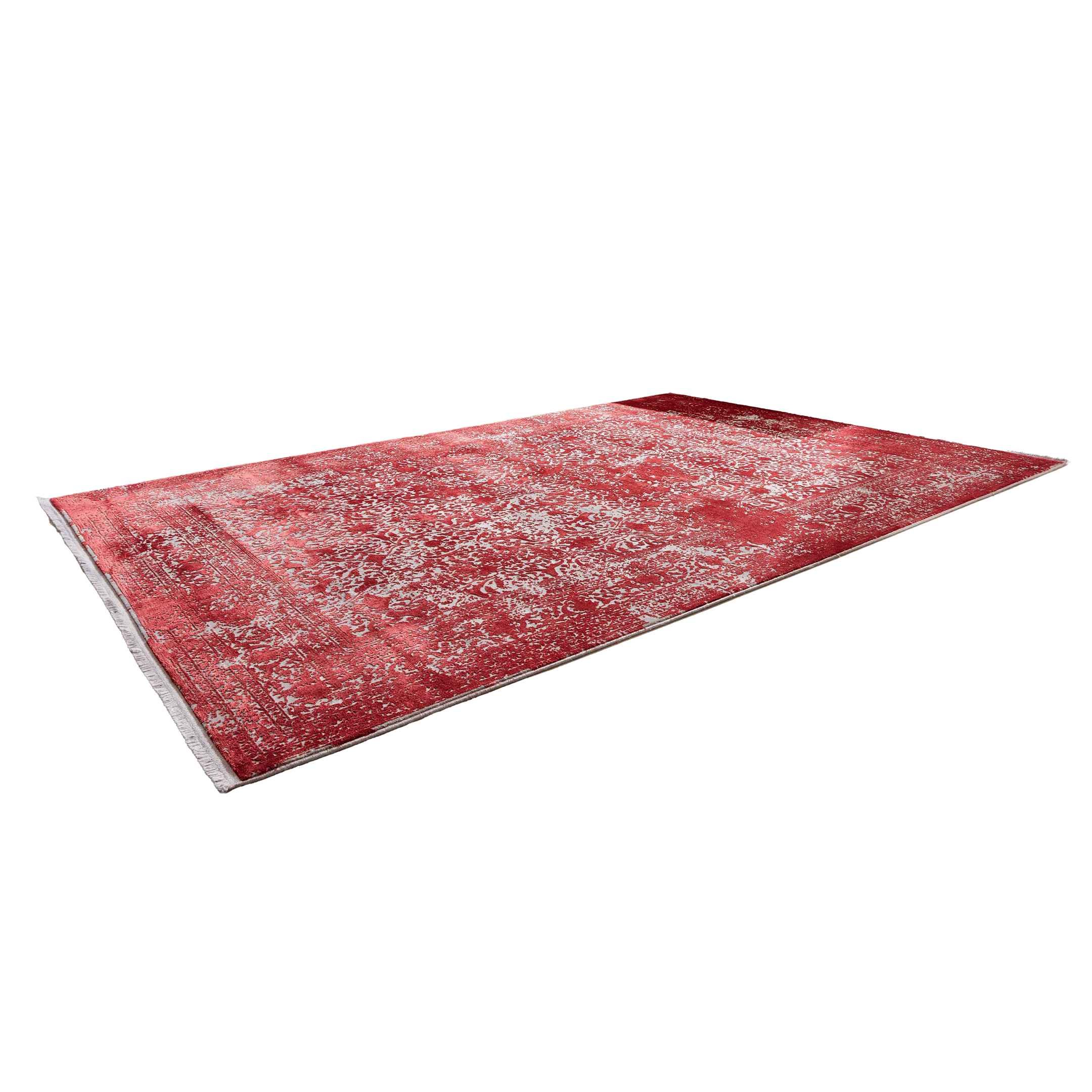 Großer roter Teppich mit hellen, ornamentalen Mustern auf hellen Dielen vor einer grauen Eckcouch mit Kissen.