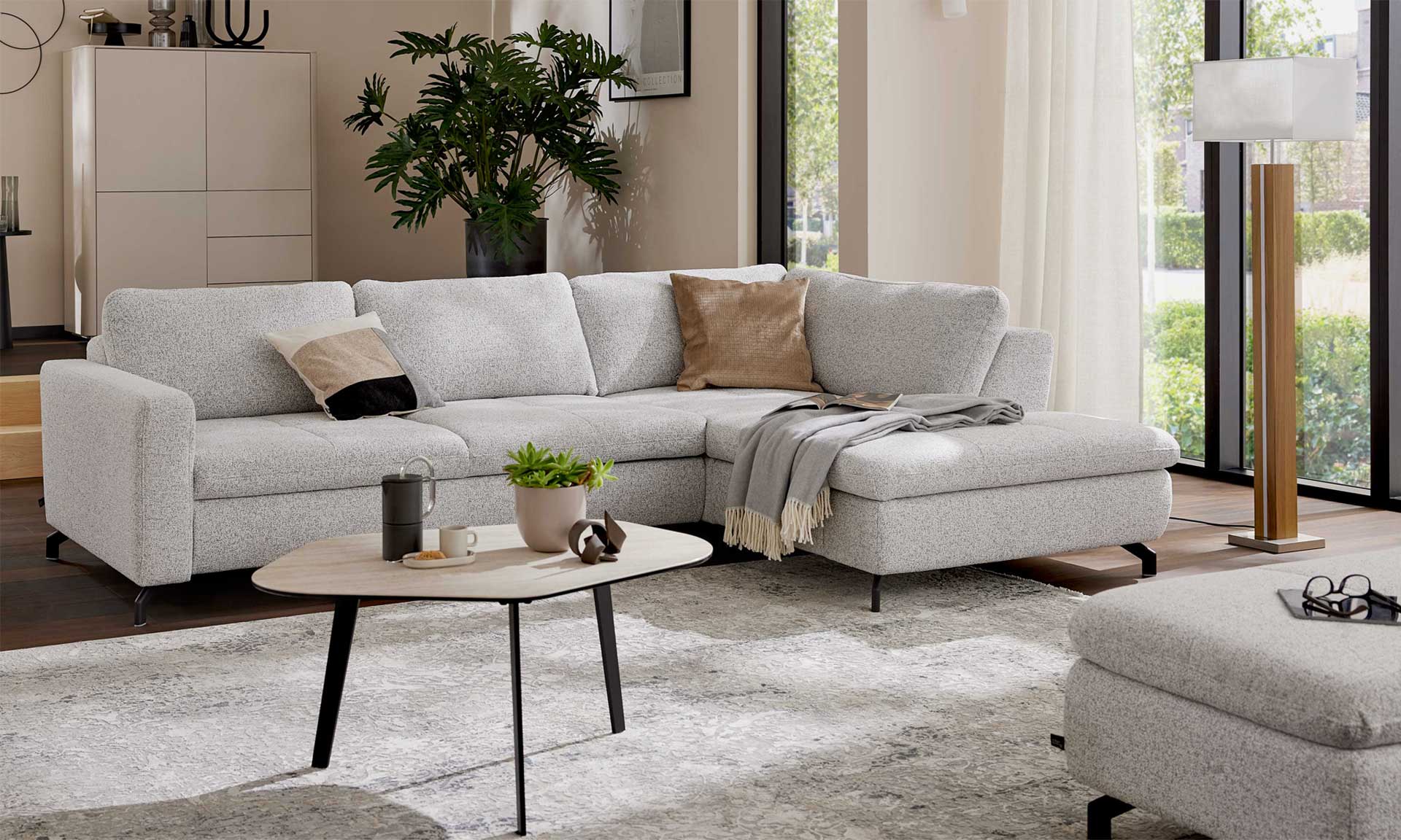 Ecksofa mit Stoffbezug in Ecru und schwarzen Metallfüßen