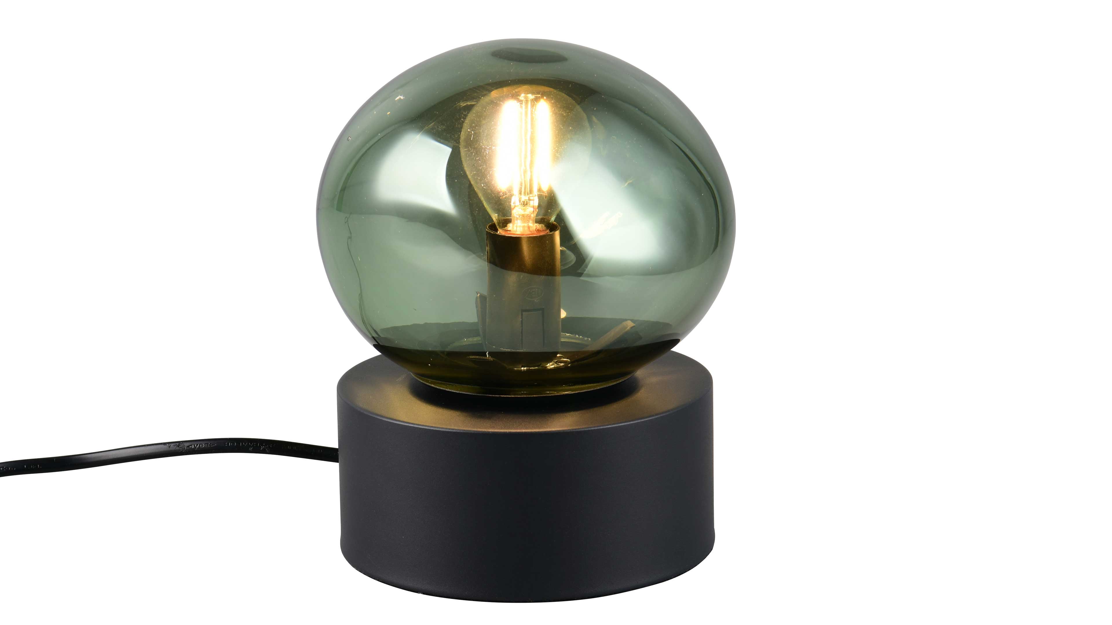 Tischlampe mit grün getöntem Glasglobus und sichtbarer Leuchtfadenbirne auf zylindrischem schwarzem Sockel mit Kabel.