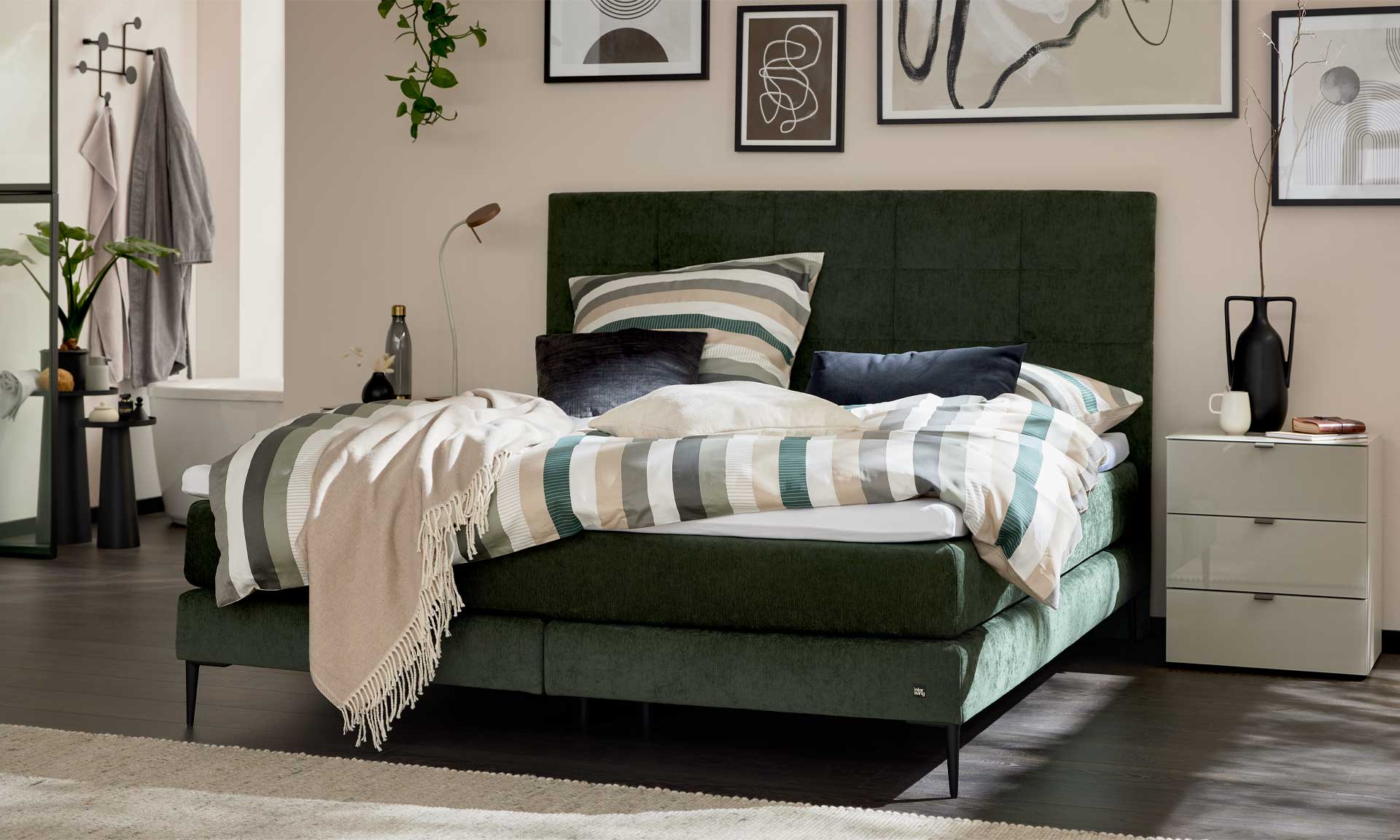 Moosgrünes Boxspringbett mit extra hohem Kopfteil und stoffbezogenen Matratzen