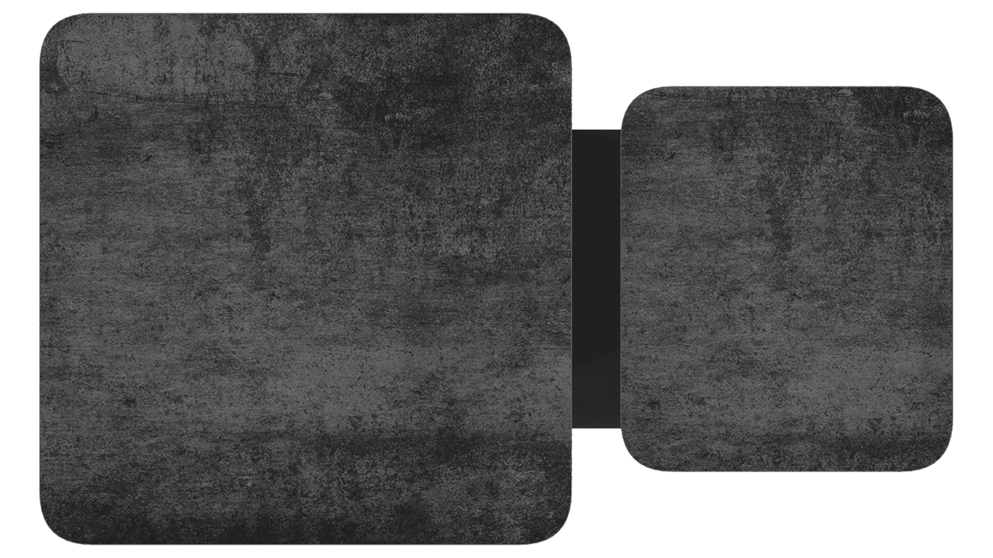 Zwei dunkelgraue, abgerundete Rechteckflächen mit grober, betonähnlicher Struktur, links groß, rechts kleiner, mittig verbunden.