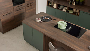 Einbauküche Interliving aus Holz in Dunkelgrün Interliving Küche Serie 3083 mit AEG Einbaugeräten Black Green & Nussbaum Kuba  - dreizeilig